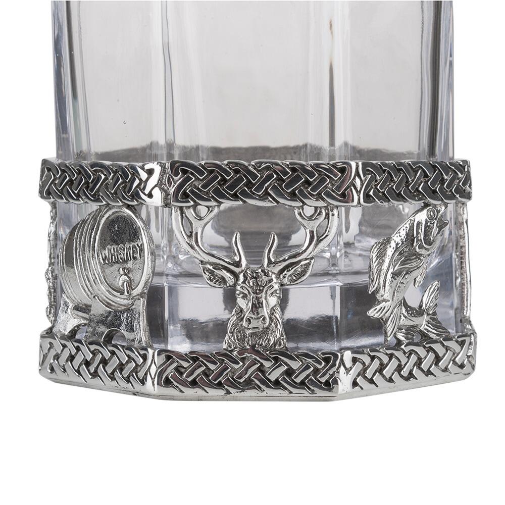 A glass decanter with a Pewter base showing a stag