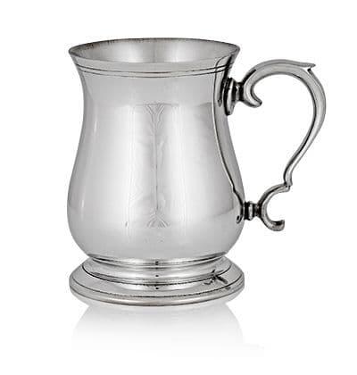 Polished silver tankard with ornate handle and base