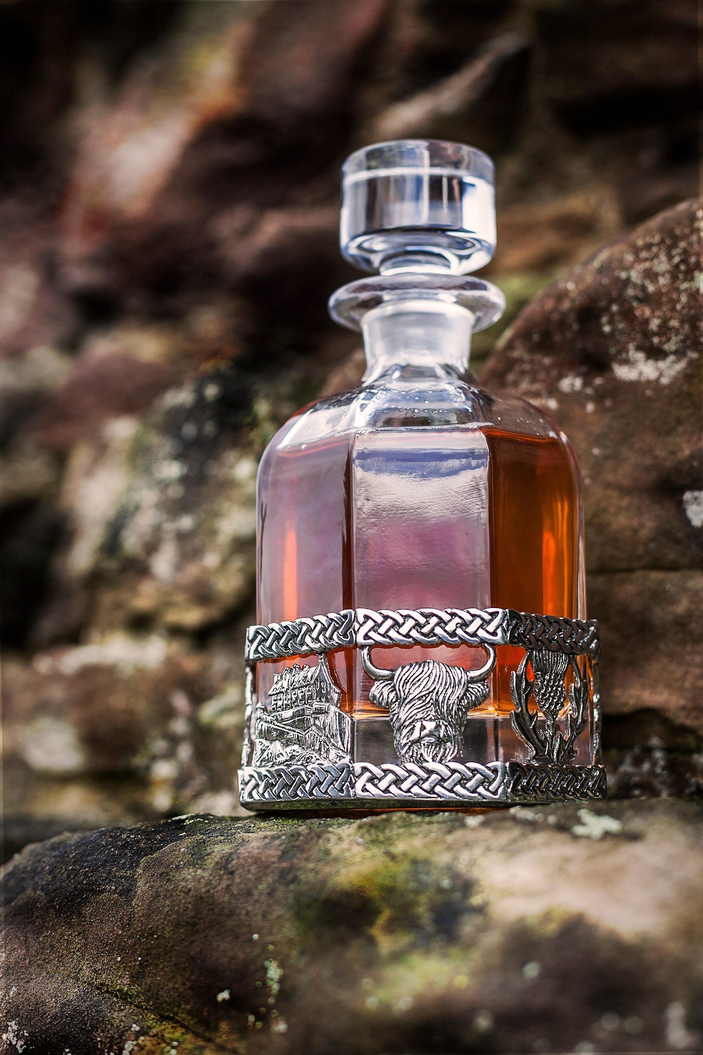 A scottish designed decanter sitting on rocks