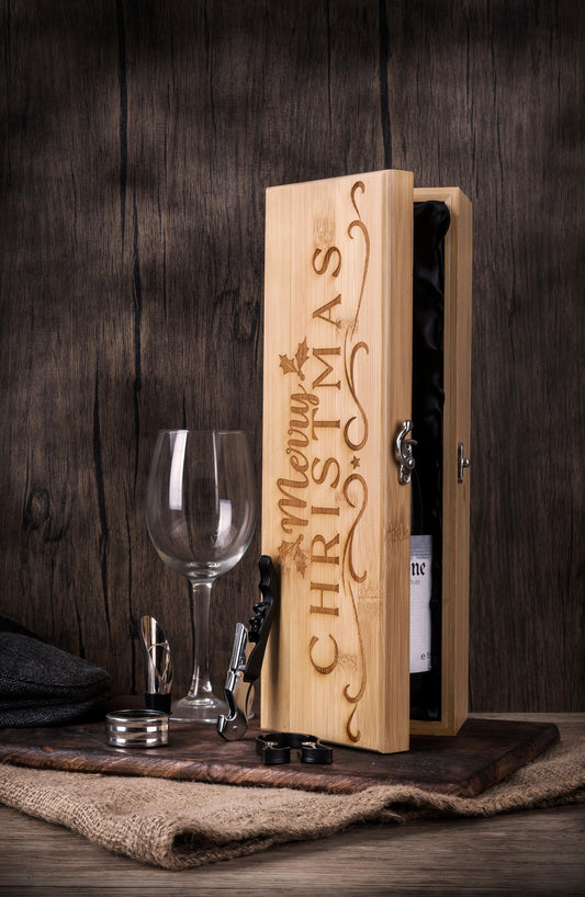 Festive Christmas wooden presentation box with holly leaf design and decorative engraving, featuring luxury wine accessories