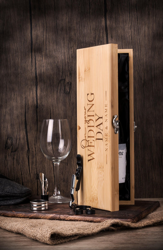 Personalised bamboo Wedding wooden presentation box with luxury wine accessories and engraved names, displayed with wine glass and accessories