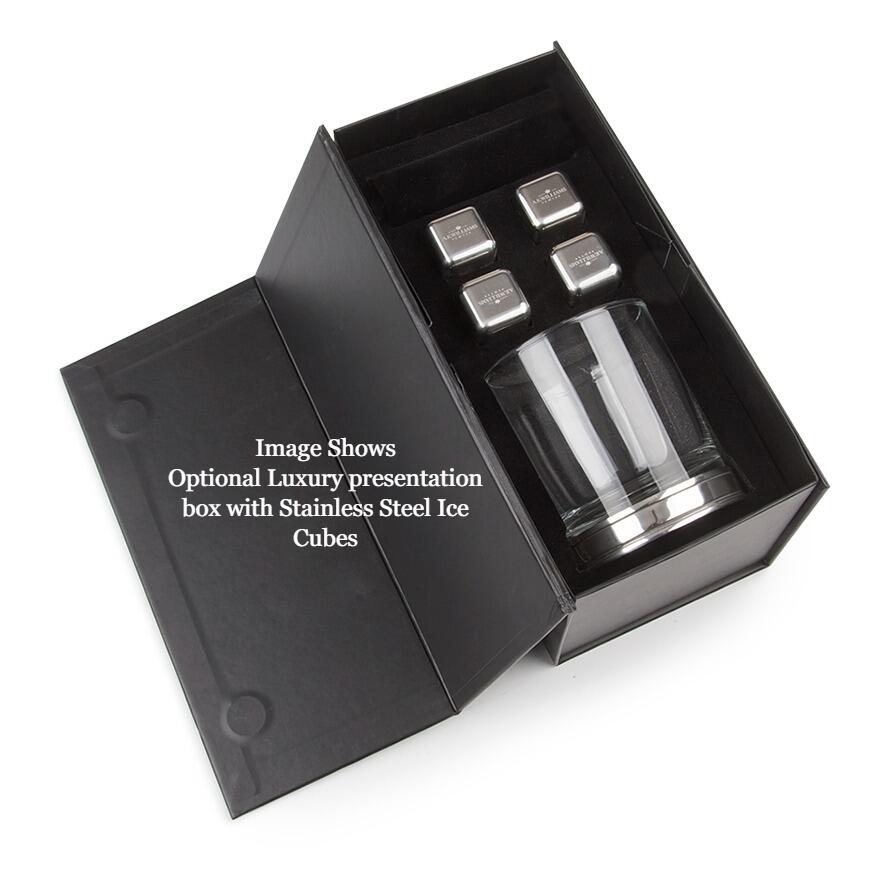 The glass contains an amber-coloured whiskey, and is placed on a round pewter base. The stainless steel ice cubes are cubic in shape and designed to chill the drink without diluting it.