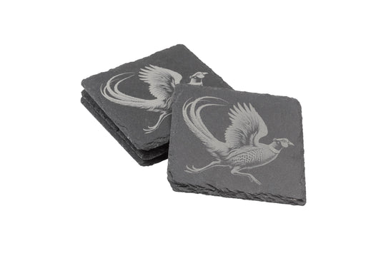 Two stacks of square slate coasters, each engraved with a detailed Pheasant design.