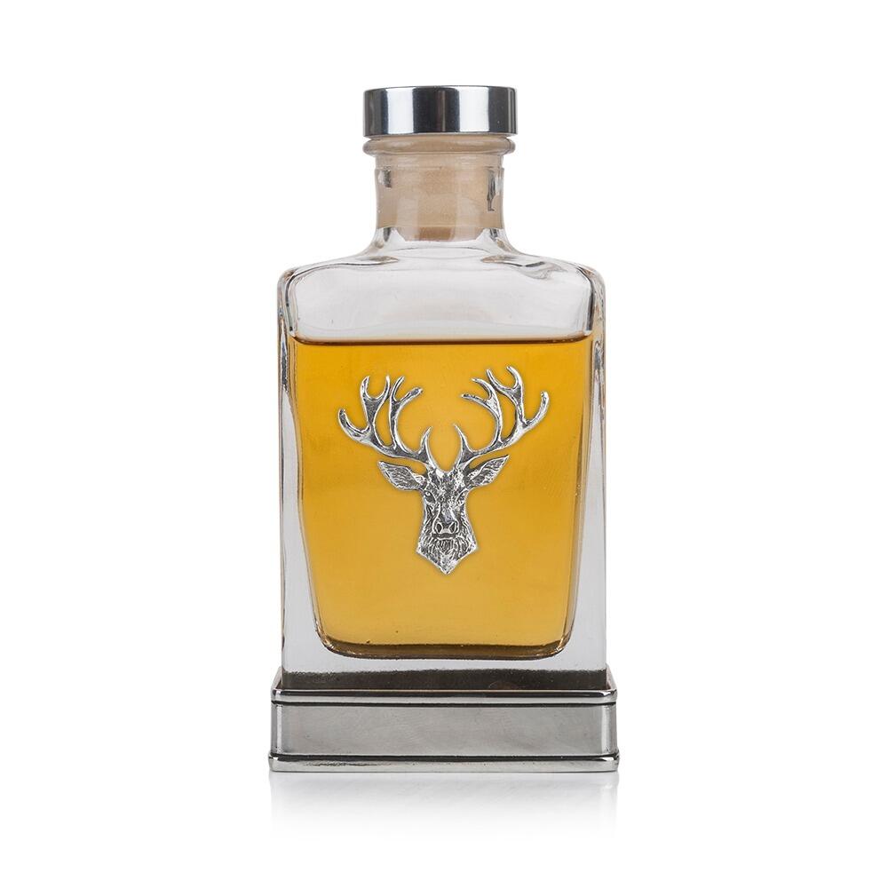 A glass flask with a Pewter base and Pewter stags head on the front