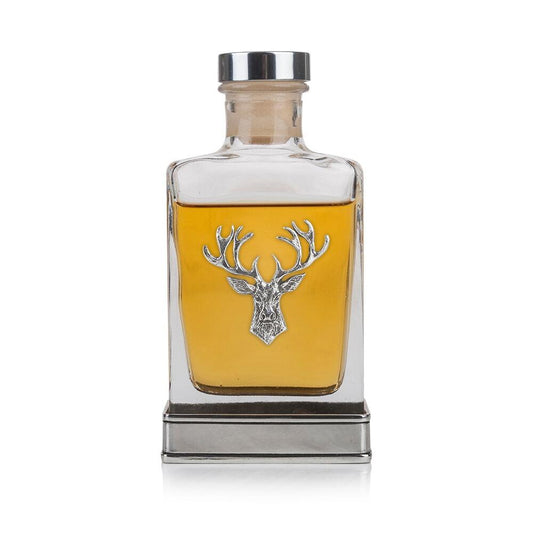 A glass flask with a Pewter base and Pewter stags head on the front