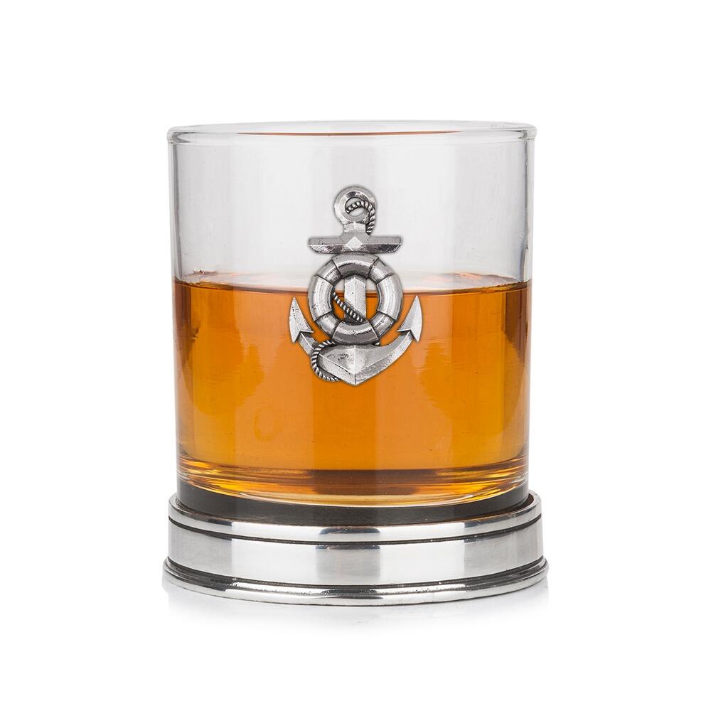 Whisky tumbler with pewter anchor emblem and polished base, partially filled with amber liquid