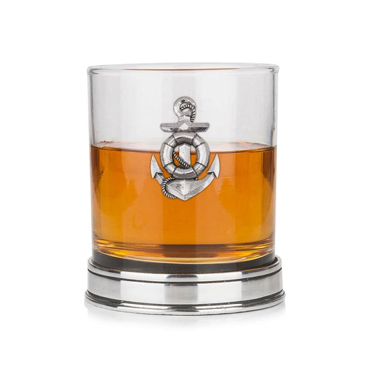 Whisky tumbler with pewter anchor emblem and polished base, partially filled with amber liquid