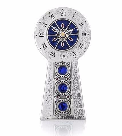 Archibald Knox Celtic pewter clock with intricate Arts & Crafts design, showcasing elegant detailing and craftsmanship.