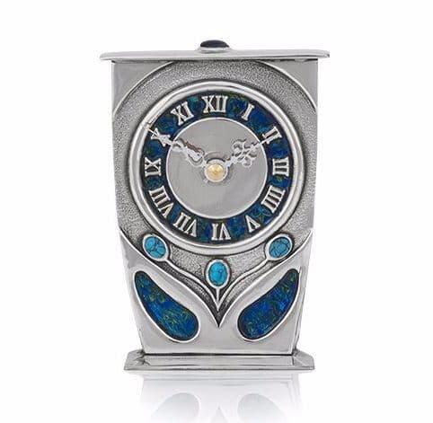 British pewter clock in Arts and Crafts style by Archibald Knox, featuring intricate design details.