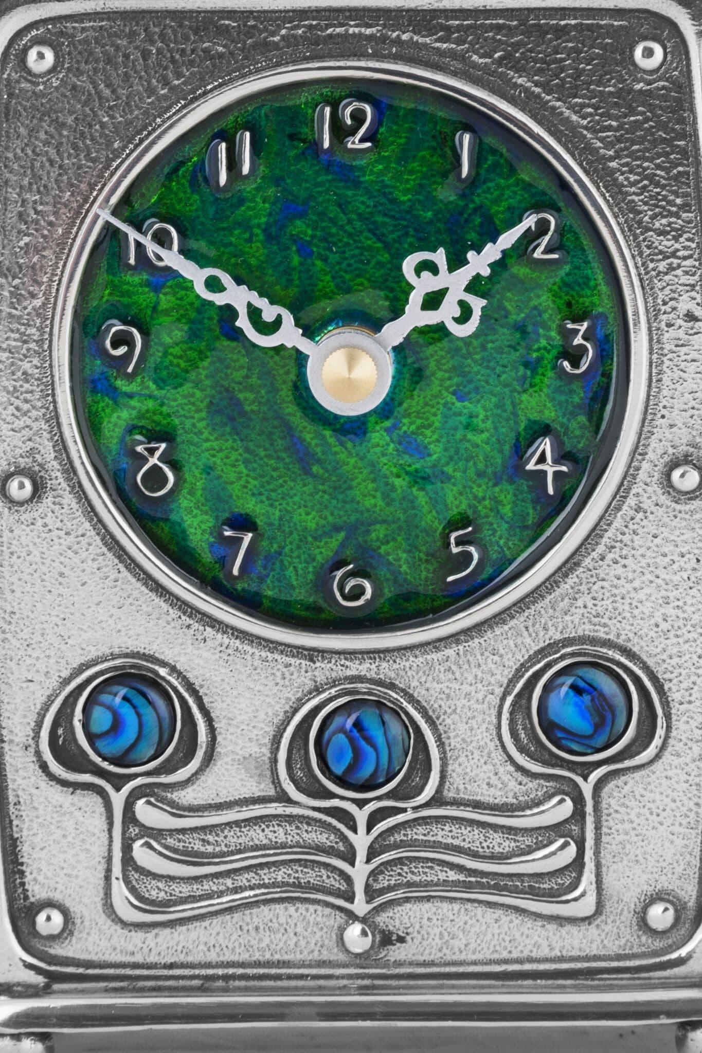 Archibald Knox pewter clock featuring intricate Arts & Crafts Celtic design, showcasing British craftsmanship.