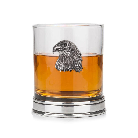 Whisky tumbler with pewter eagle emblem and polished base, partially filled with amber liquid