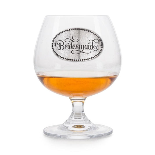 Crystal brandy snifter with pewter "Bridesmaid" badge, partially filled with amber liquid