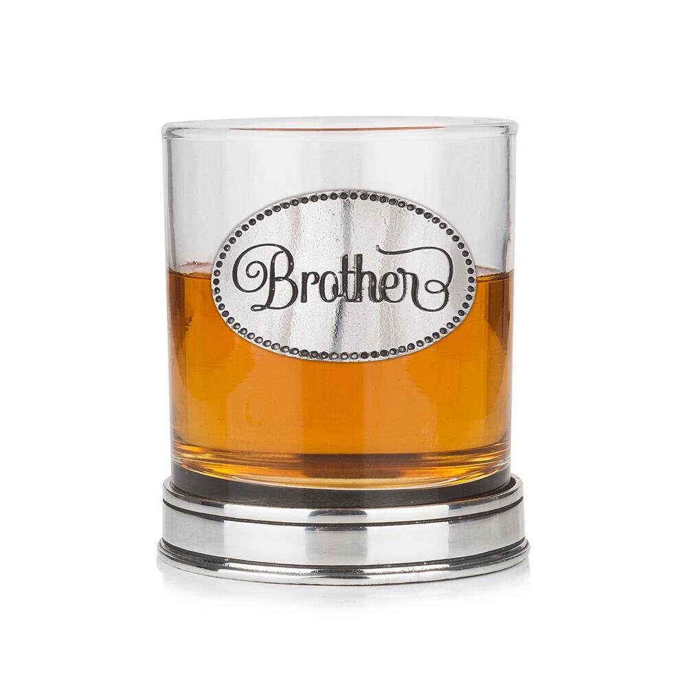 Whisky tumbler with pewter 'Brother' badge and polished base, partially filled with amber liquid