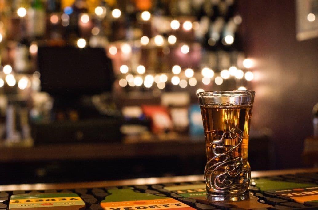 Wooden Claddagh shot glass holder with Celtic design, perfect for barware and entertaining by My Store