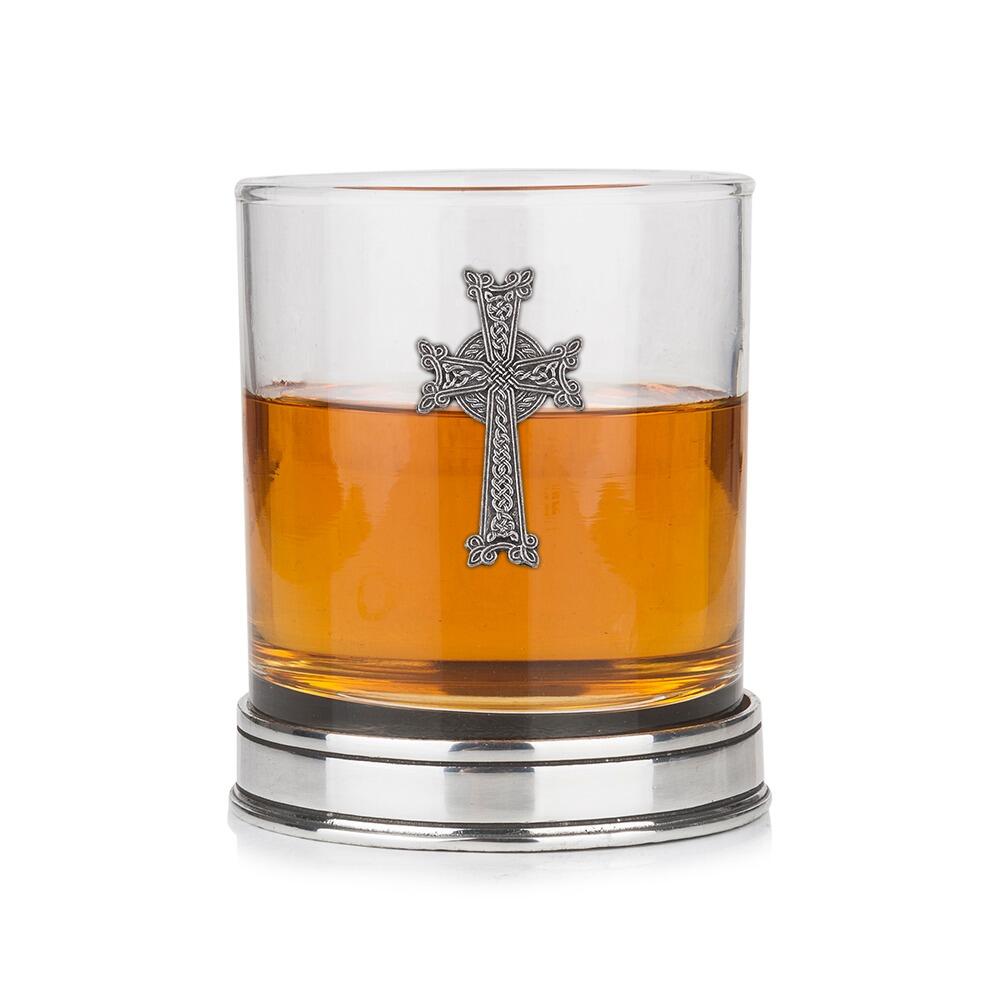 Whisky tumbler with pewter crab emblem and polished base, partially filled with amber liquid