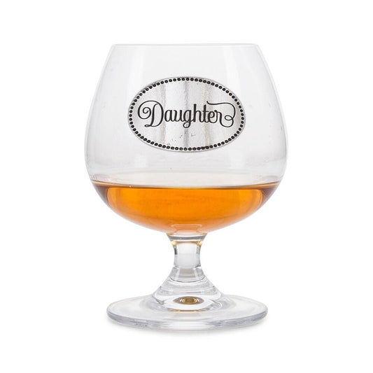 Crystal brandy glass with pewter "Daughter" badge, partially filled with amber liquid