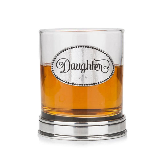 Whisky tumbler with pewter 'Daughter' badge and polished base, partially filled with amber liquid