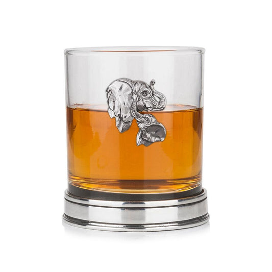 Whisky tumbler with pewter elephant emblem and polished base, partially filled with amber liquid