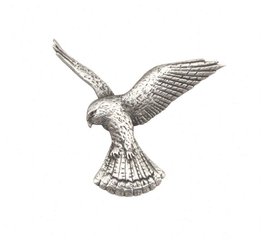 Silver metal hawk brooch with detailed wings and body in mid-flight position.