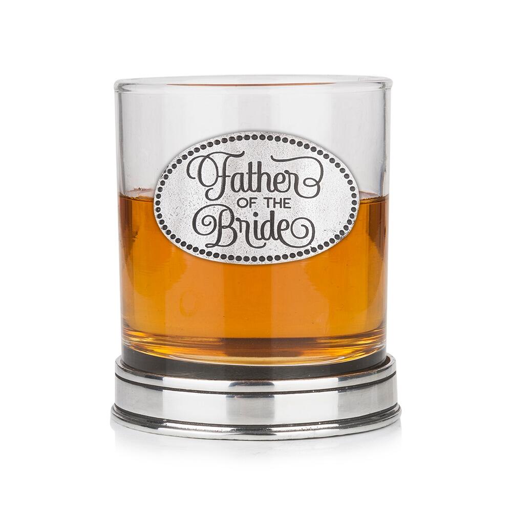 Whisky tumbler with pewter 'Father of the Bride' badge and polished base, partially filled with amber liquid