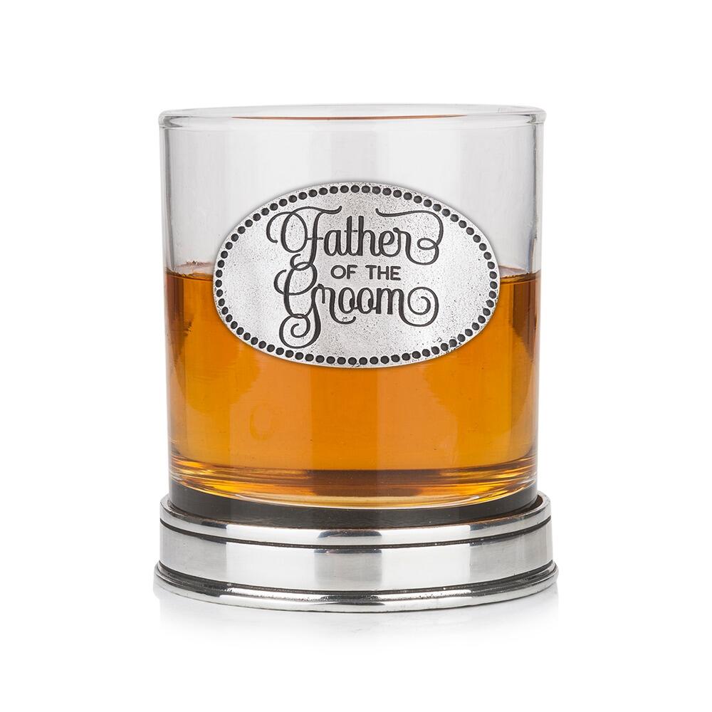 Whisky tumbler with pewter 'Father of the Groom' badge and polished base, partially filled with amber liquid