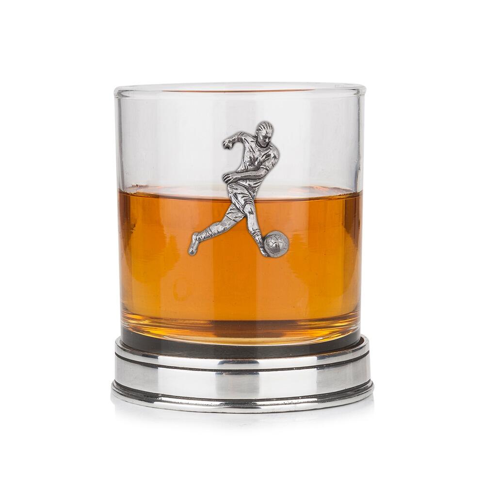 Whisky tumbler with pewter footballer emblem and polished base, partially filled with amber liquid