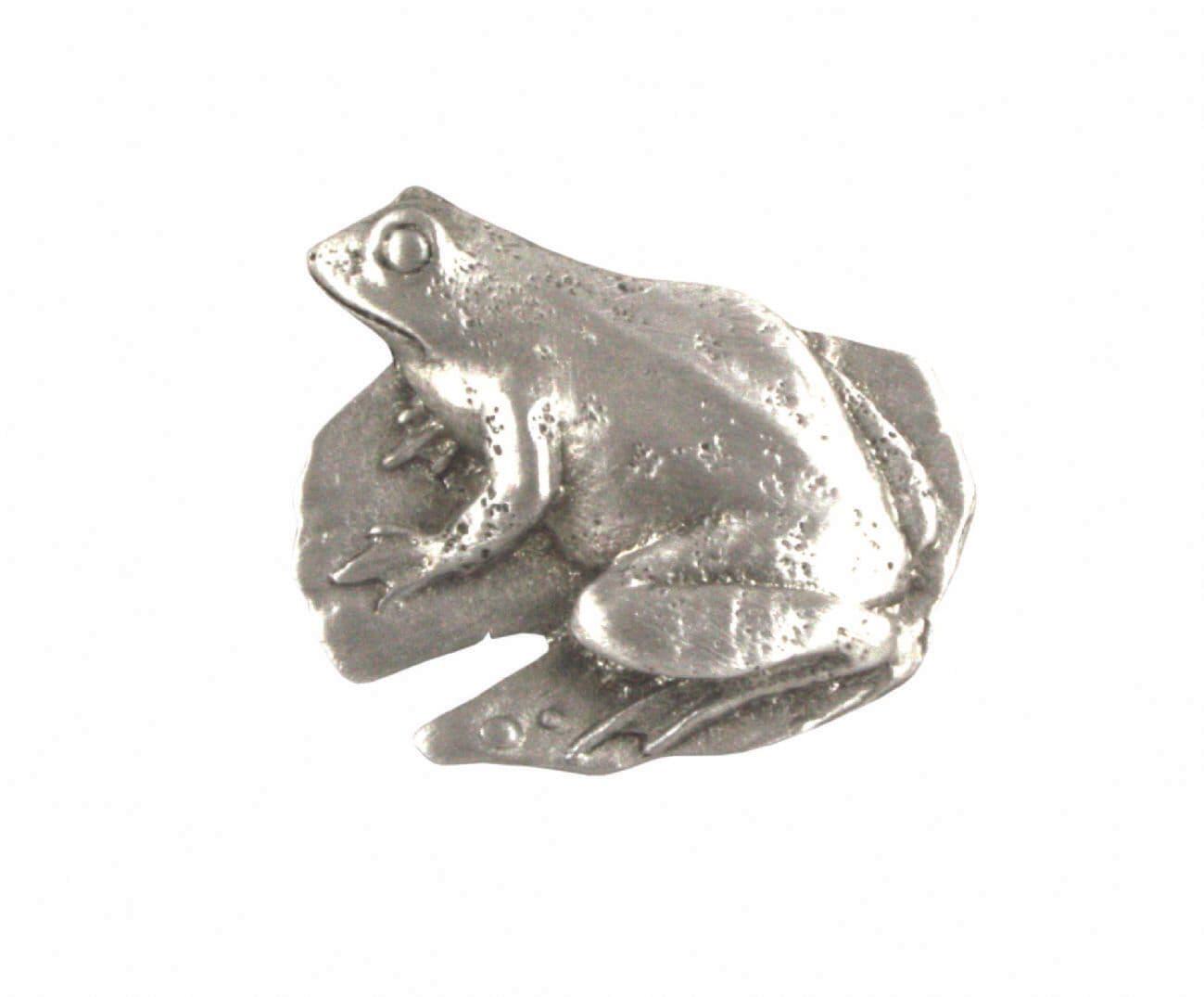 Silver frog figurine resting on a rock, detailed texture and realistic design.