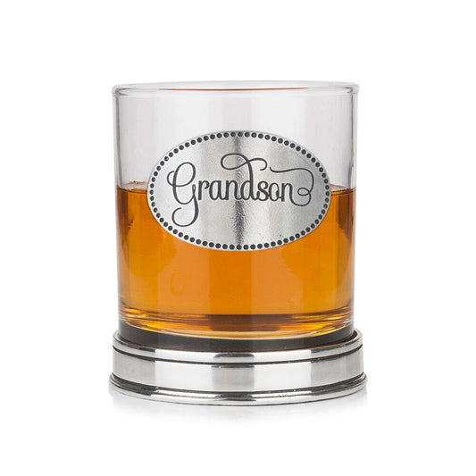 Whisky tumbler with pewter 'Grandson' badge and polished base, partially filled with amber liquid