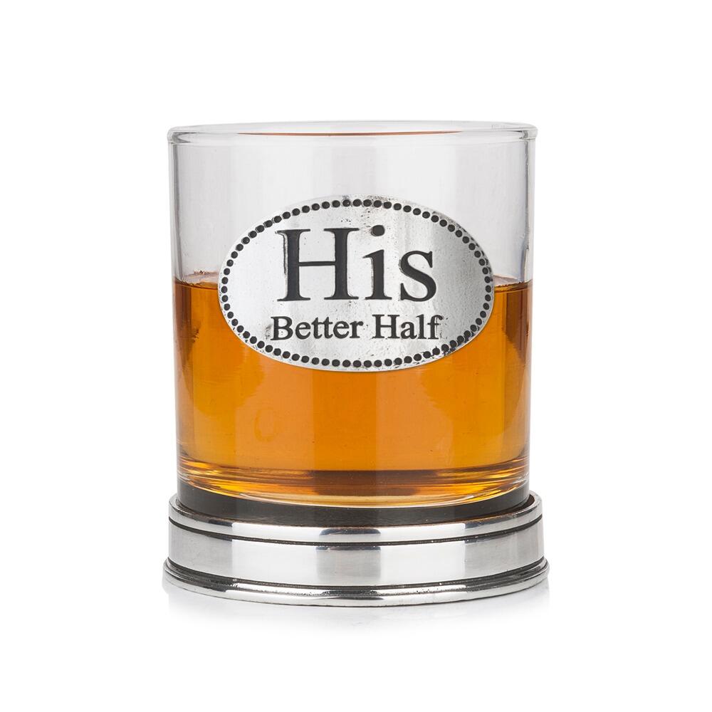 Whisky tumbler with pewter "His Better Half" badge and polished base, partially filled with amber liquid