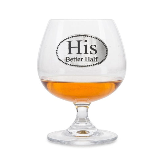 Crystal brandy glass with pewter "His Better Half" emblem, partially filled with amber liquid