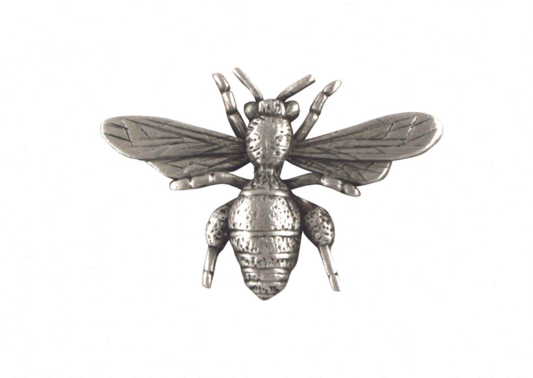 Silver bee brooch with detailed wings and body design.