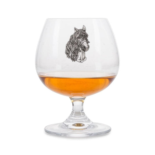 Crystal brandy glass with pewter horse emblem, partially filled with amber liquid