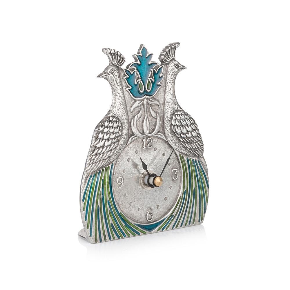Pewter desk clock featuring two peacocks with blue and green enamelled feathers in William Morris style from a side view