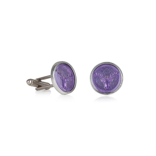 Close-up of handcrafted pewter cufflinks featuring a detailed stag head embossed with transparent lilac enamel