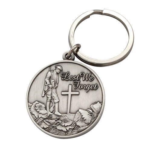 Silver keychain featuring a soldier and cross design with "Lest We Forget" inscription.