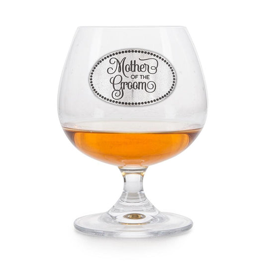 Elegant crystal brandy glass with pewter "Mother of the Groom" badge, partially filled with amber liquid