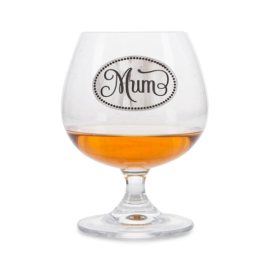 Elegant crystal brandy glass with pewter "Mum" badge, partially filled with amber liquid
