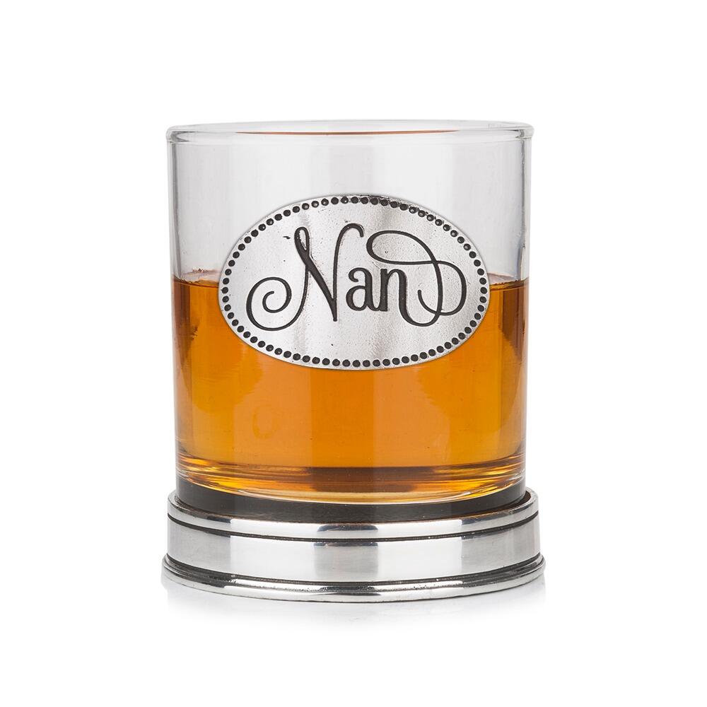 Whisky tumbler with pewter 'Nan' badge and polished base, partially filled with amber liquid  Copy Retry   Claude can make mistakes. Please double-check responses.
