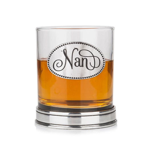 Whisky tumbler with pewter 'Nan' badge and polished base, partially filled with amber liquid  Copy Retry   Claude can make mistakes. Please double-check responses.