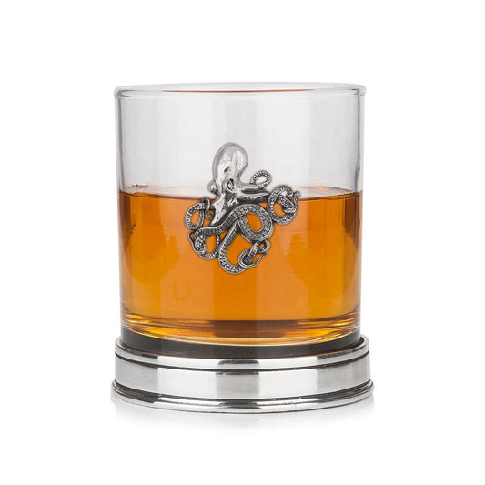 Whisky tumbler with pewter octopus motif and polished base, partially filled with amber liquid