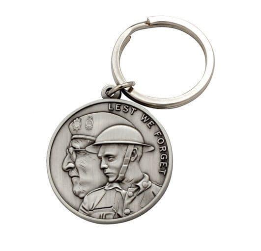 Silver keychain featuring a commemorative coin design with "Lest We Forget" and soldier imagery.