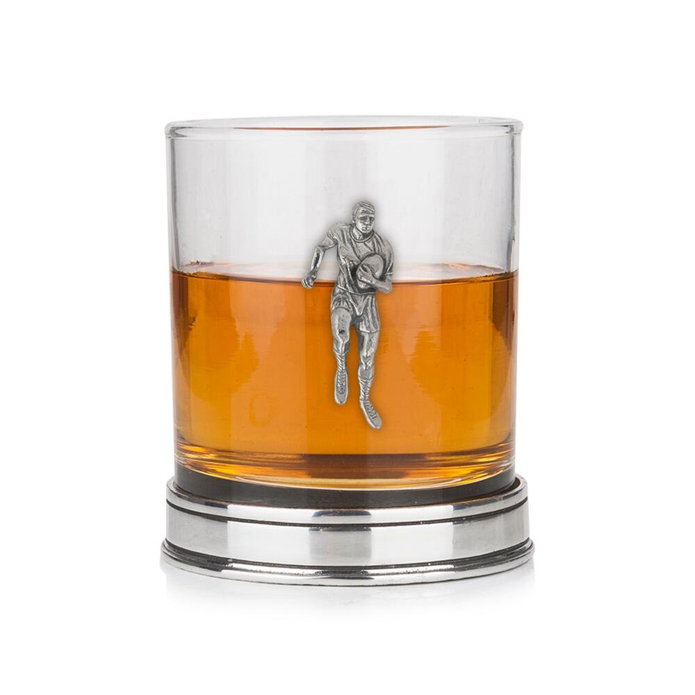 Whisky tumbler with pewter rugby player motif and polished base, partially filled with amber liquid
