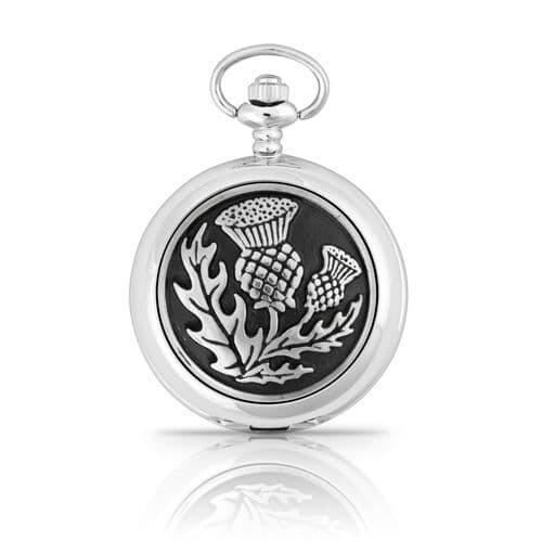 Silver pocket watch featuring thistle design on a black background.