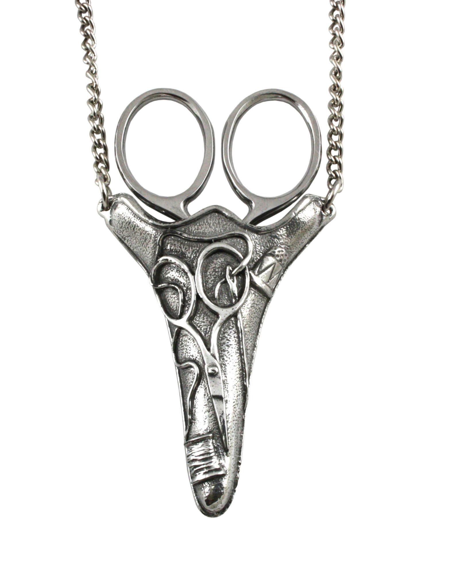 Silver pendant necklace featuring a unique scissor design with a chain.