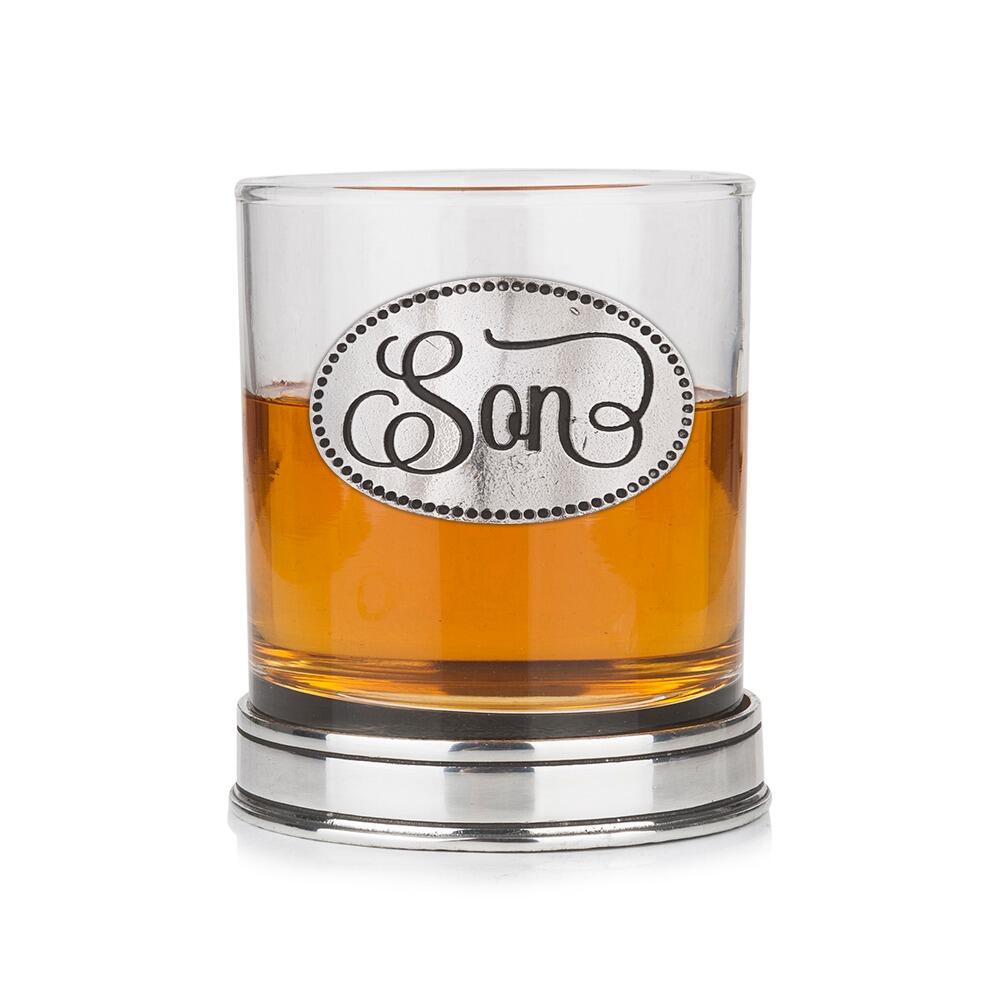 Whisky tumbler with pewter 'Son' badge and polished base, partially filled with amber liquid