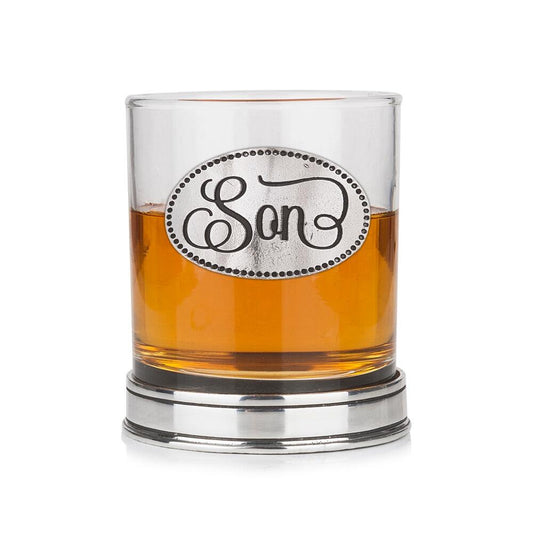 Whisky tumbler with pewter 'Son' badge and polished base, partially filled with amber liquid