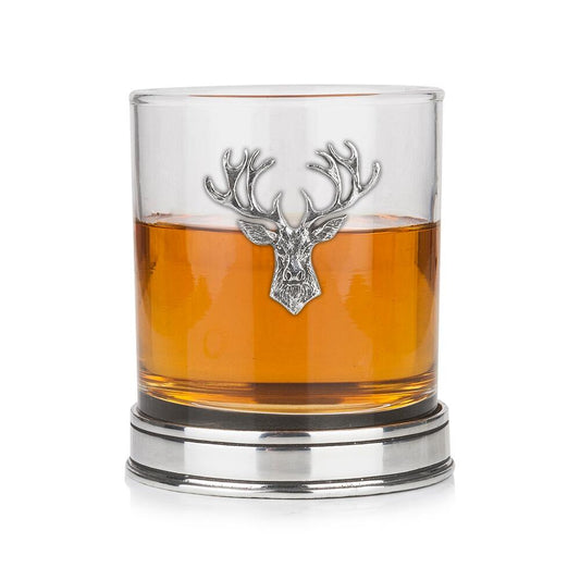 a whisky tumbler with a pewter stag icon and base filled with whisky