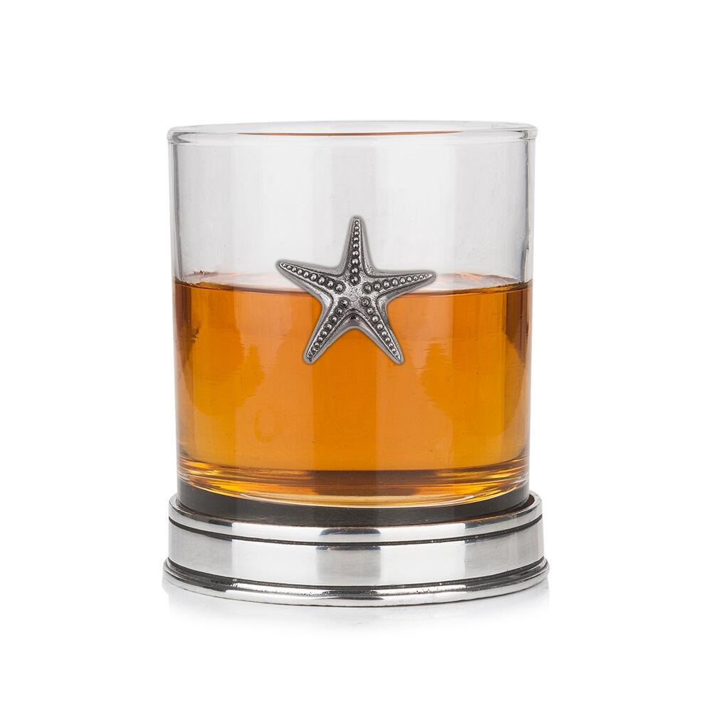 Whisky tumbler with pewter starfish motif and polished base, partially filled with amber liquid