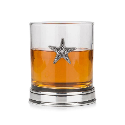Whisky tumbler with pewter starfish motif and polished base, partially filled with amber liquid