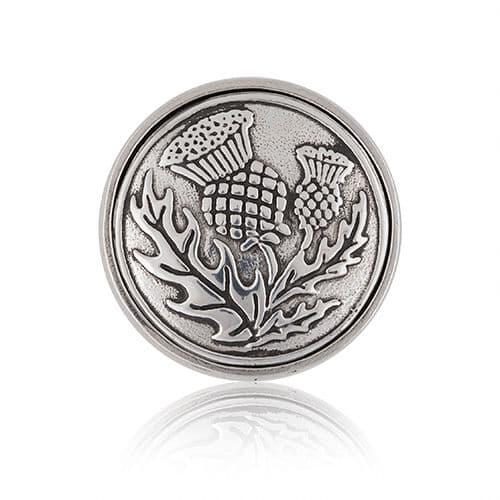 Silver thistle design brooch with detailed engraving and polished finish.